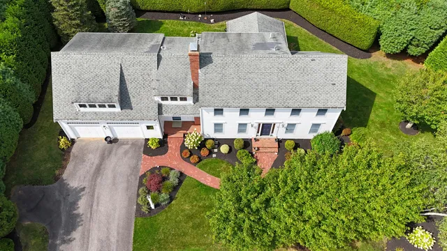 an aerial view of a house with pool and garden
