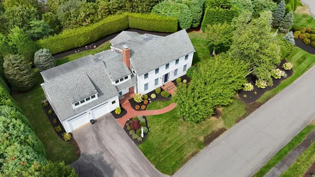 an aerial view of a house with a yard swimming pool and outdoor seating