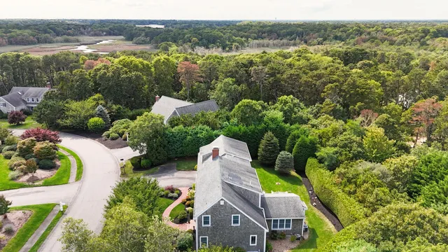 an aerial view of a house with a yard and lake view
