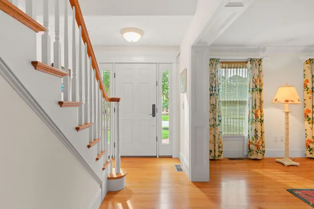 a view of an entryway with wooden floor