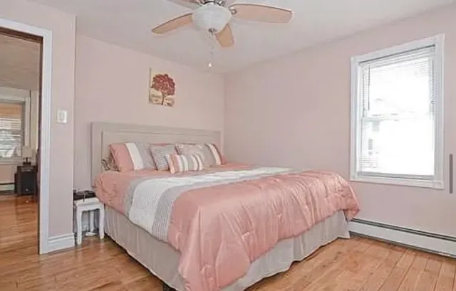 a bedroom with a bed and a window