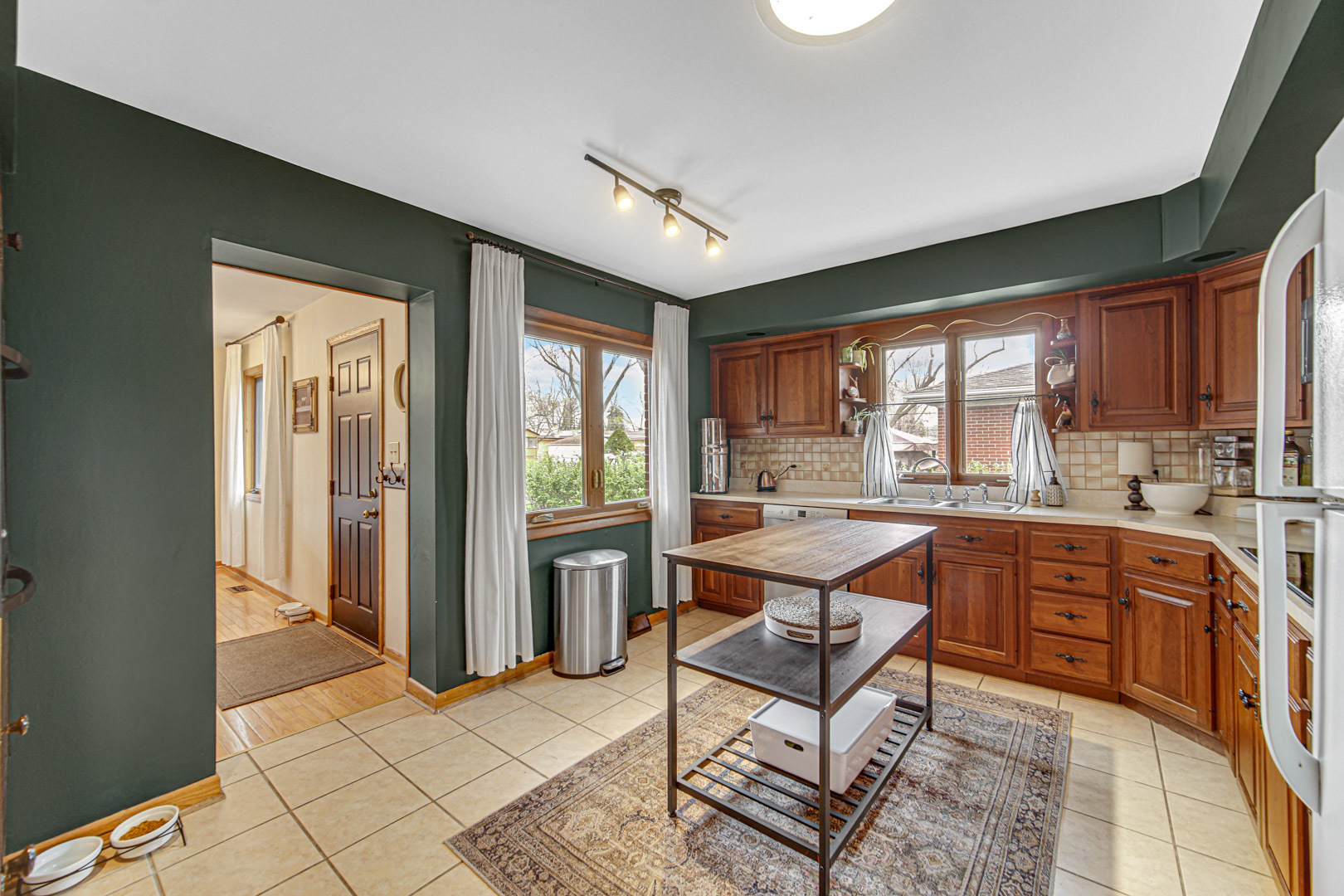 1202 Birch Drive Mount Prospect, IL 60056 - Photo 4 of 22 a large open kitchen with stainless steel appliances granite countertop a stove a refrigerator and a sink with granite countertops