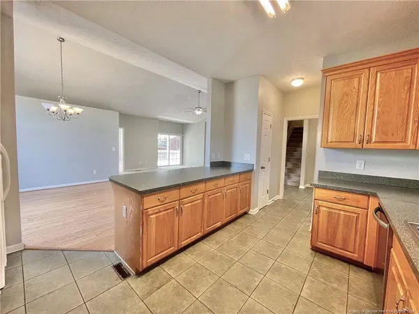 a large kitchen with stainless steel appliances granite countertop a stove a sink and a refrigerator
