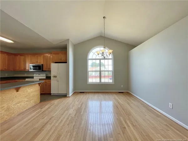 a view of a kitchen with a sink dishwasher and wooden floor