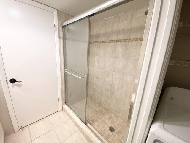 3134 Southwest 20th Terrace, Unit 11D Delray Beach, FL 33445 - Photo 8 of 14 a bathroom with a glass shower door