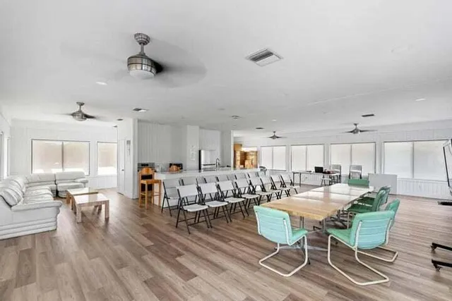 a living room with lots of furniture and kitchen view