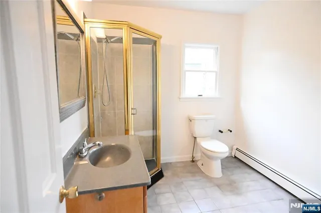a bathroom with a sink toilet and mirror