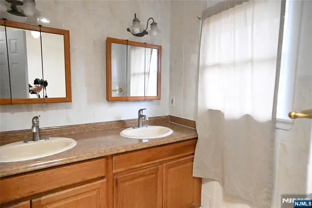 a bathroom with 2 sink and a mirror