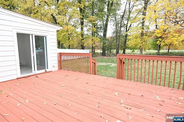 a outside view of a house with a wooden deck