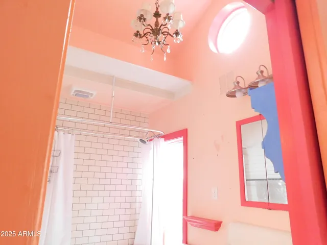 a view of a house with large windows and a small yard