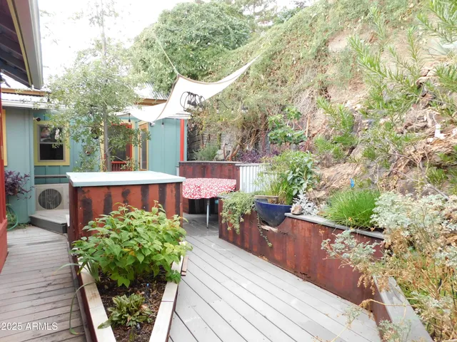 a room with wooden floor and outdoor seating