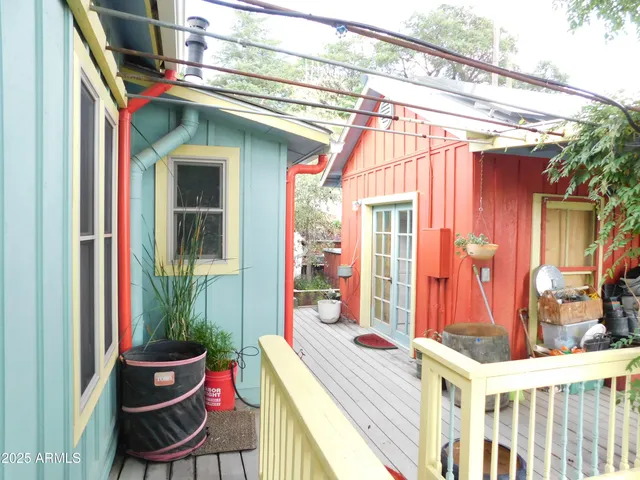 a view of a house with a small yard and wooden fence