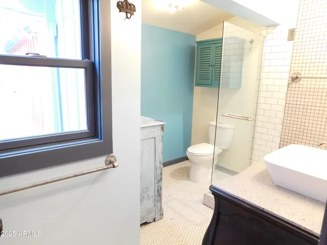 a view of a room with wooden floor and fan