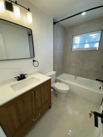 a bathroom with a sink a toilet and a bathtub