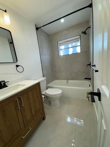 a spacious bathroom with a sink a toilet and a bathtub