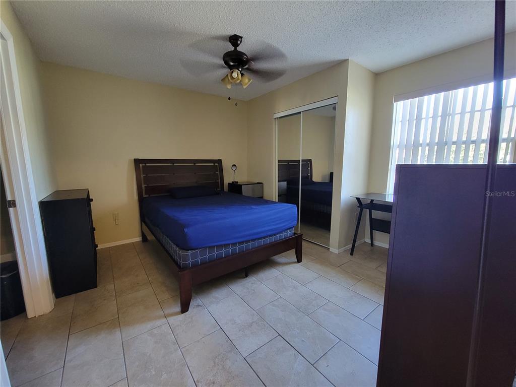 3705 Southwest 27th Street, Unit 1016 Gainesville, FL 32608 - Photo 12 of 31 a bedroom with a bed and a dresser