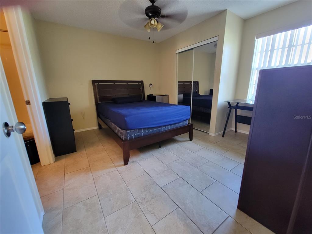 3705 Southwest 27th Street, Unit 1016 Gainesville, FL 32608 - Photo 13 of 31 a bedroom with furniture and a window