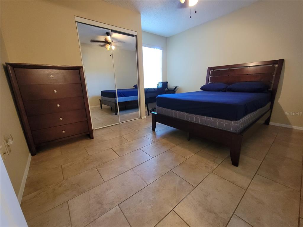 3705 Southwest 27th Street, Unit 1016 Gainesville, FL 32608 - Photo 17 of 31 a bedroom with a bed and a dresser