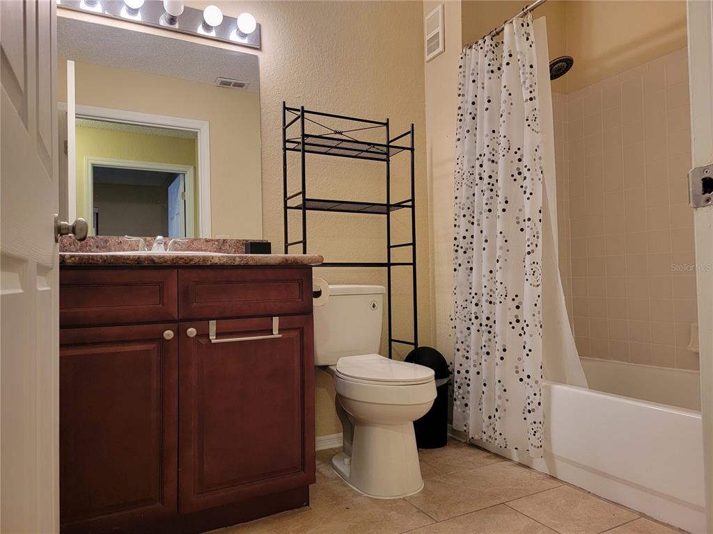 3705 Southwest 27th Street, Unit 1016 Gainesville, FL 32608 - Photo 19 of 31 a bathroom with a sink a toilet and shower