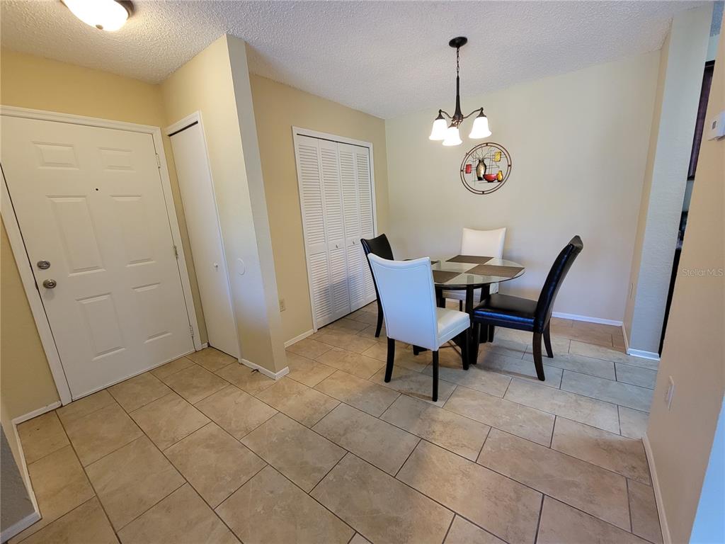 3705 Southwest 27th Street, Unit 1016 Gainesville, FL 32608 - Photo 8 of 31 a view of a dining room with furniture and chandelier