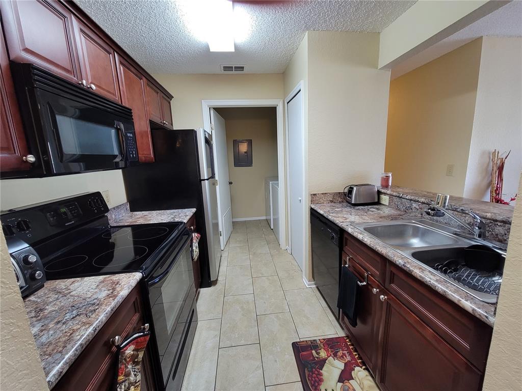 3705 Southwest 27th Street, Unit 1016 Gainesville, FL 32608 - Photo 10 of 31 a kitchen with a sink stove and cabinets