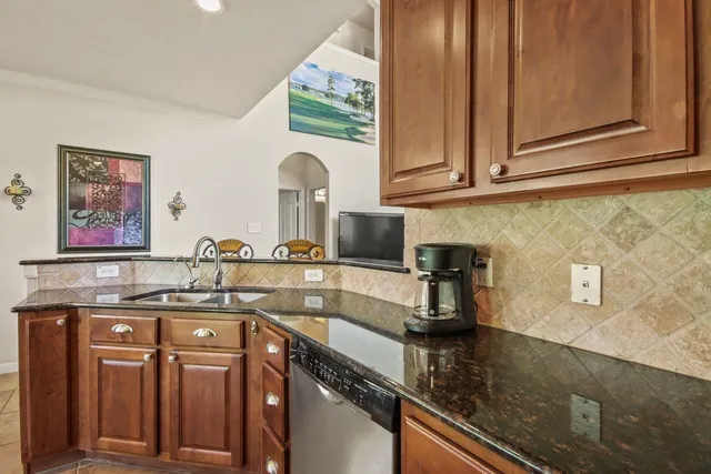 a kitchen with stainless steel appliances granite countertop a stove a refrigerator and a microwave