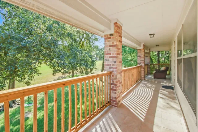 a view of a balcony with wooden floor