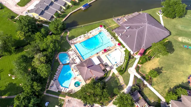 an aerial view of a residential houses with yard