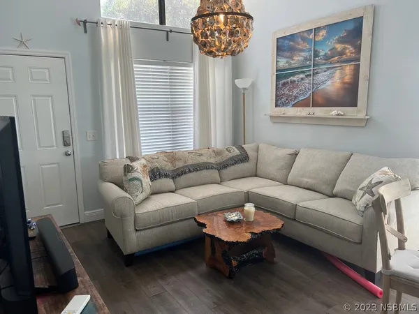 a kitchen with stainless steel appliances a stove a sink dishwasher a refrigerator a microwave oven with cabinets and wooden floor