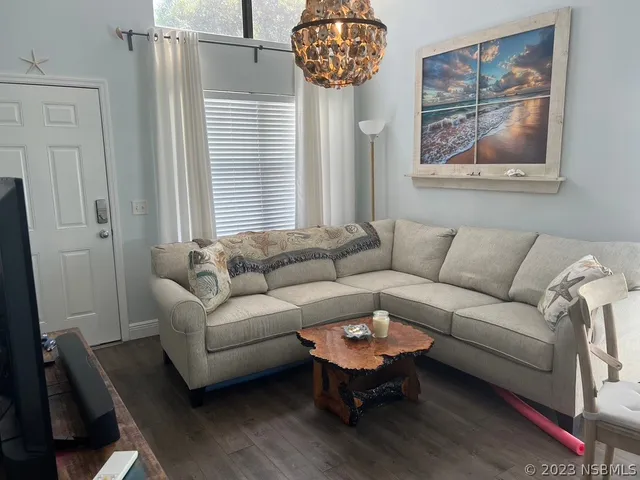 a kitchen with stainless steel appliances a stove a sink dishwasher a refrigerator a microwave oven with cabinets and wooden floor