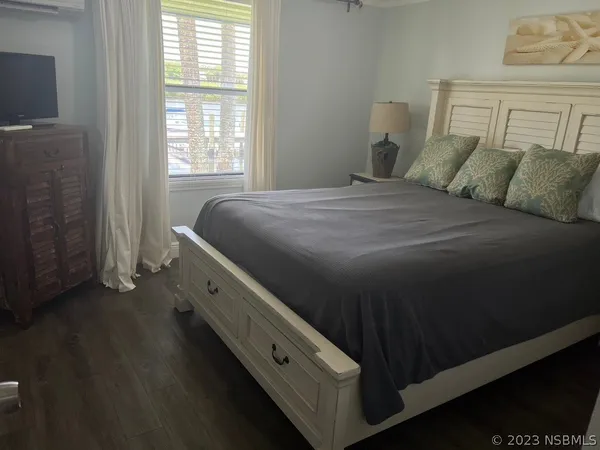 a bathroom with a granite countertop sink vanity mirror and toilet