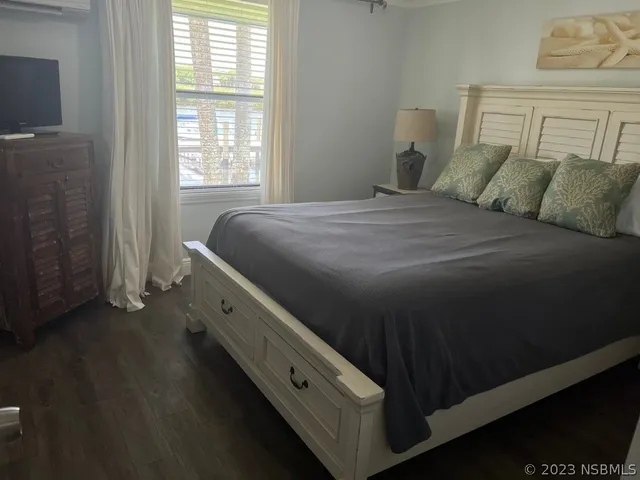 a bathroom with a granite countertop sink vanity mirror and toilet