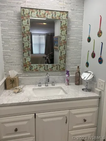 a bathroom with a sink and a mirror