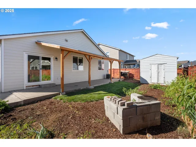 a backyard of a house with table and chairs