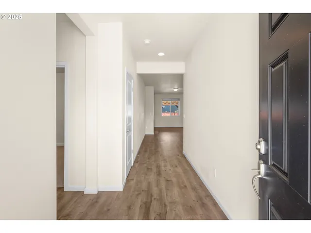 a view of hallway with wooden floor