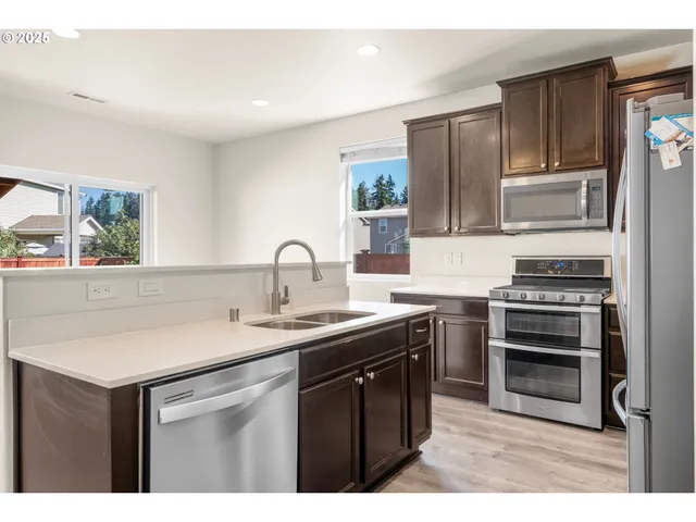 a kitchen with a sink appliances and cabinets