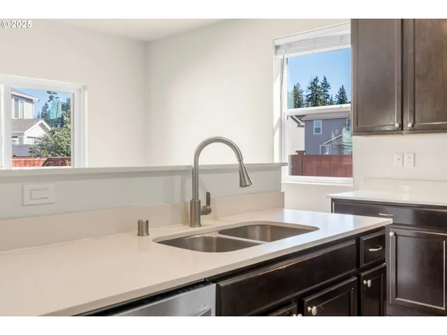 a kitchen with a sink and a stove top oven