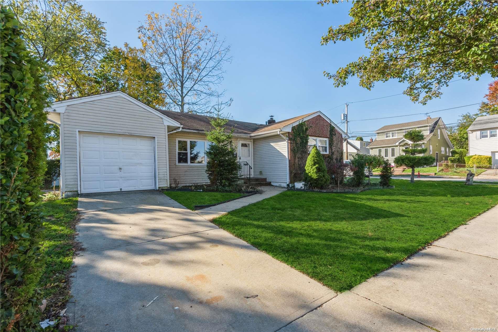 4 Jesse Street Freeport, NY 11520 - Photo 1 of 1 a view of a white house next to a yard and trees