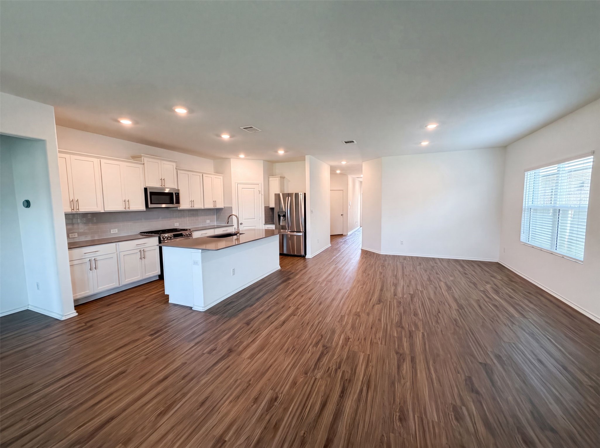 424 Wolf Springs Road Georgetown, TX 78628 - Photo 7 of 15 A streamlined kitchen flows into a spacious living area, complete with a generous island.