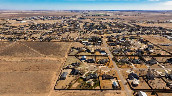 an aerial view of residential houses with city view
