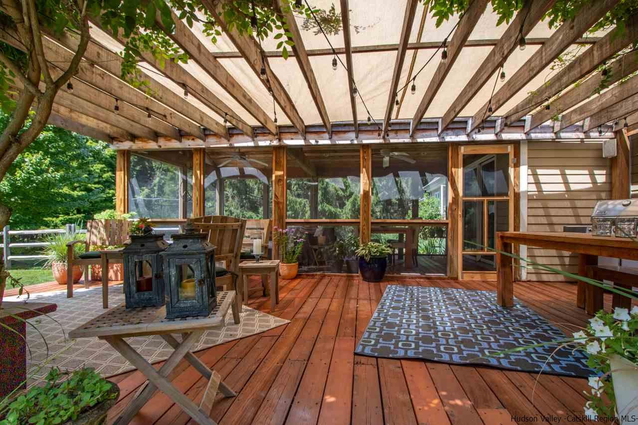 173 Peak Road Stone Ridge, NY 12484 - Photo 15 of 34 a view of a patio with table and chairs barbeque potted plants and large tree