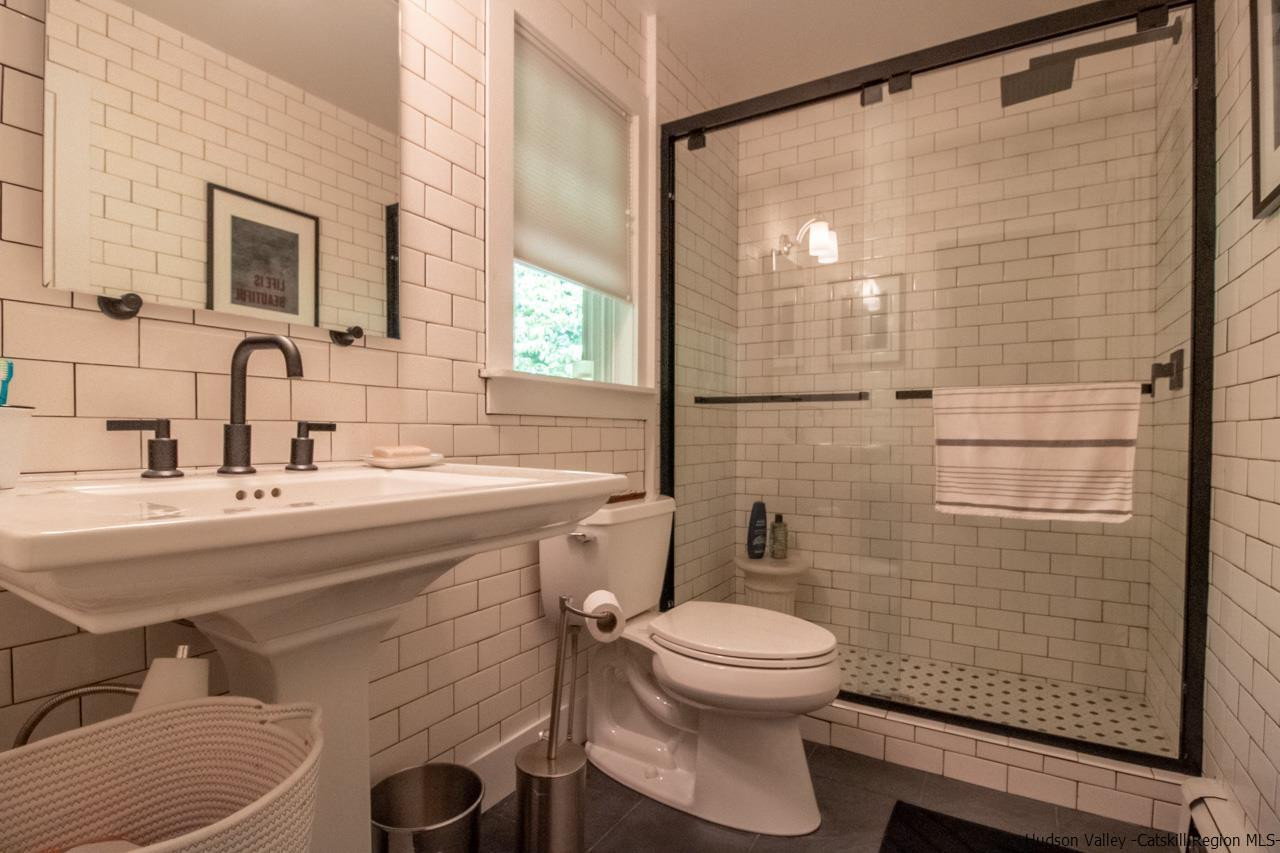 173 Peak Road Stone Ridge, NY 12484 - Photo 23 of 34 a bathroom with a sink a toilet and shower