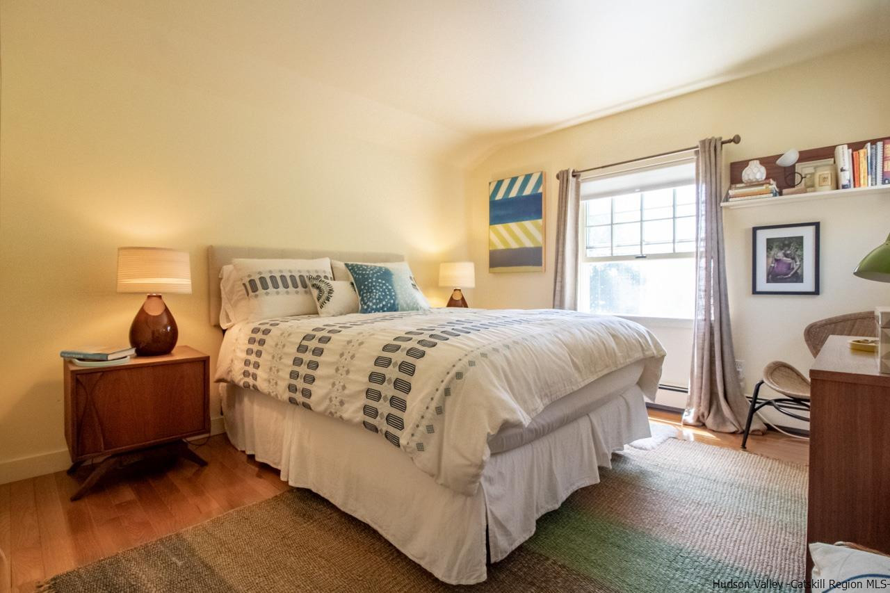 173 Peak Road Stone Ridge, NY 12484 - Photo 25 of 34 a bedroom with a bed and wooden floor