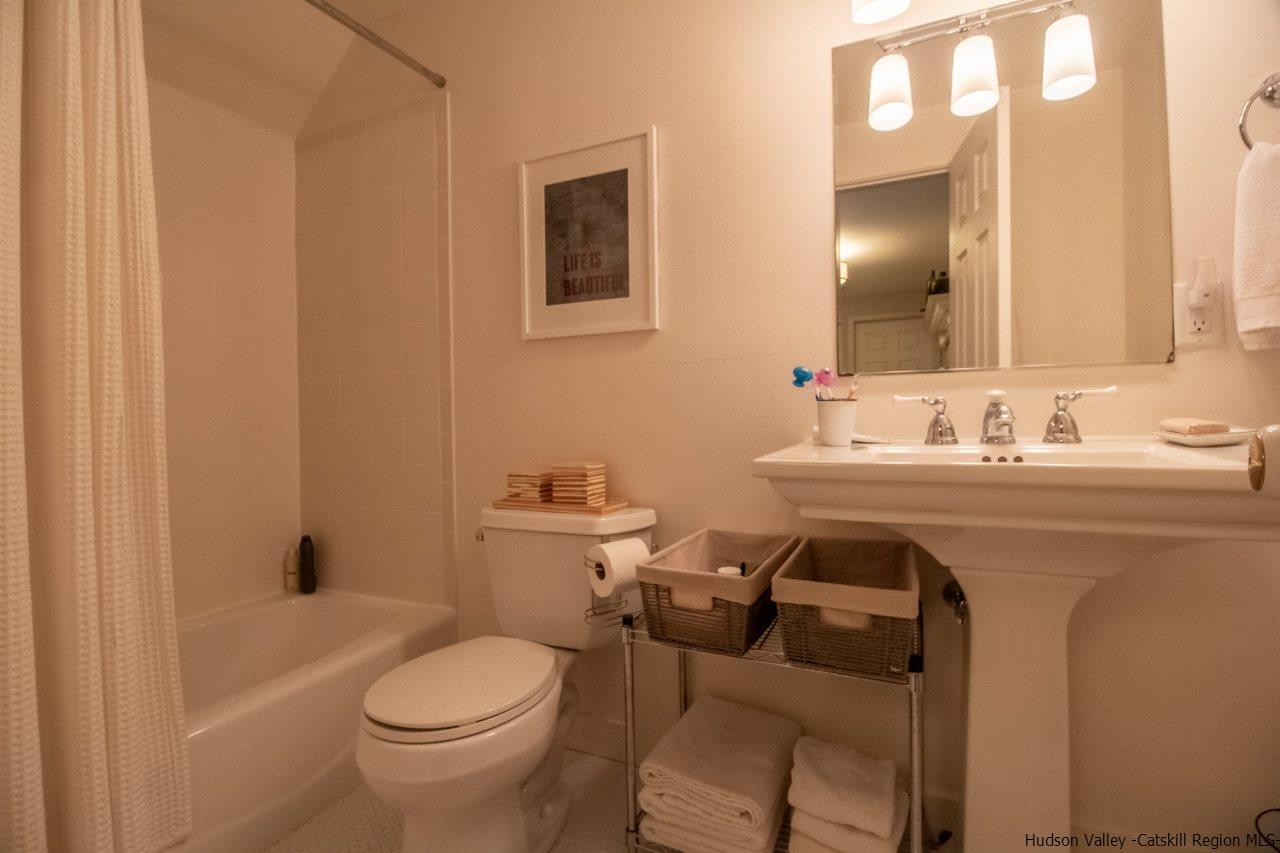 173 Peak Road Stone Ridge, NY 12484 - Photo 26 of 34 a bathroom with a sink toilet and mirror