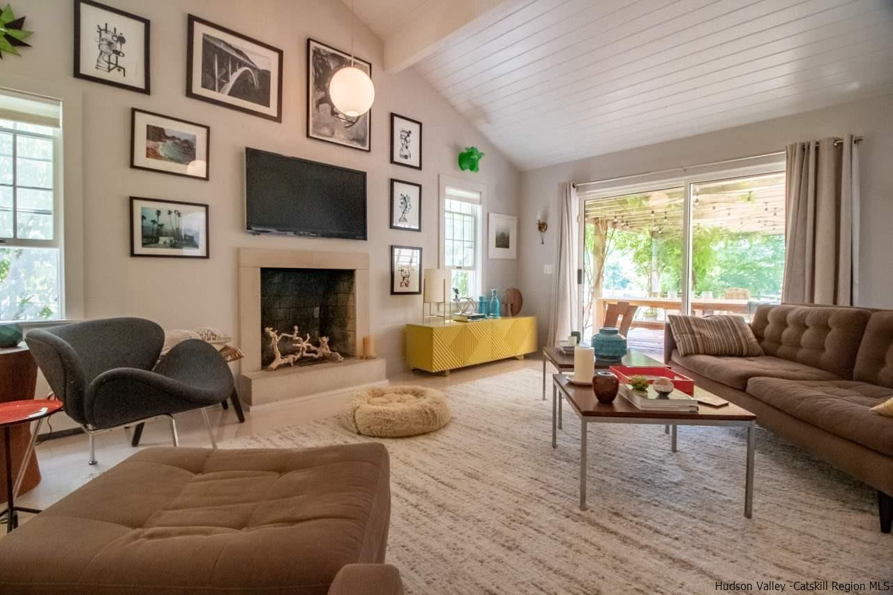 173 Peak Road Stone Ridge, NY 12484 - Photo 6 of 34 a living room with furniture fireplace and a large window