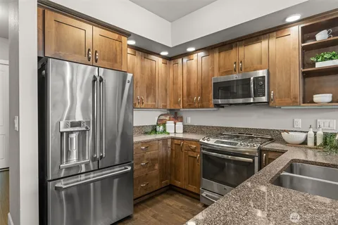 a kitchen with a refrigerator stove and microwave