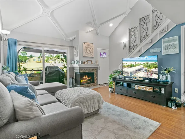 a living room with furniture a fireplace and a flat screen tv