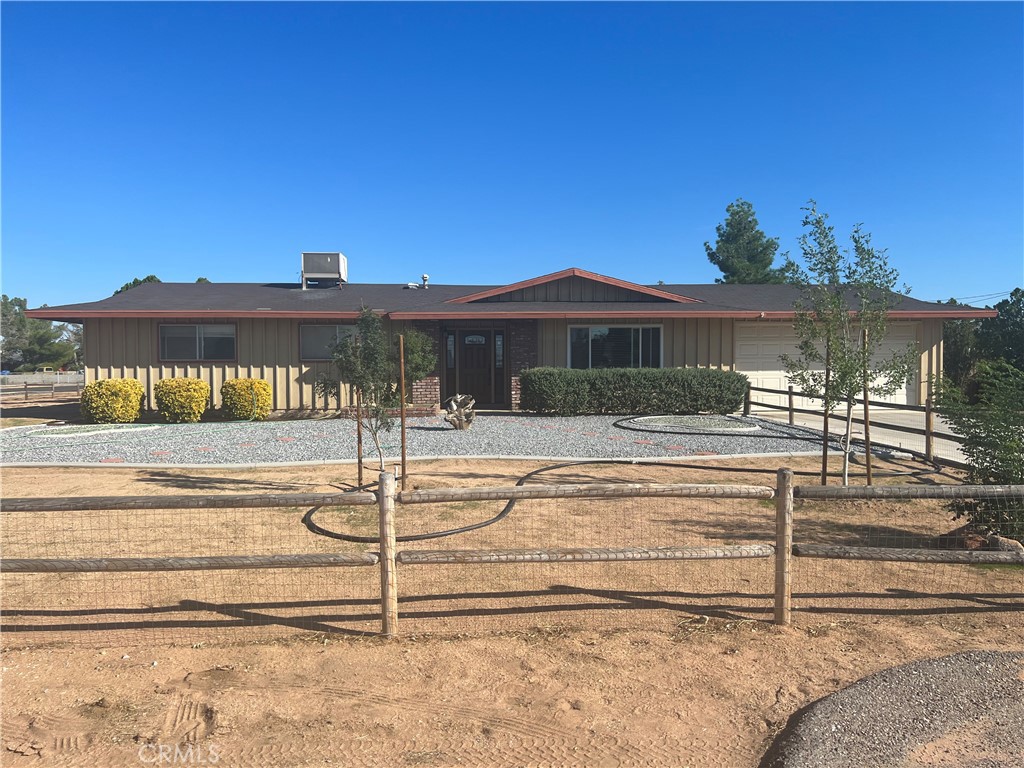 13791 Mohawk Road Apple Valley, CA 92307 - Photo 1 of 1 a view of a white house with a big yard and large tree