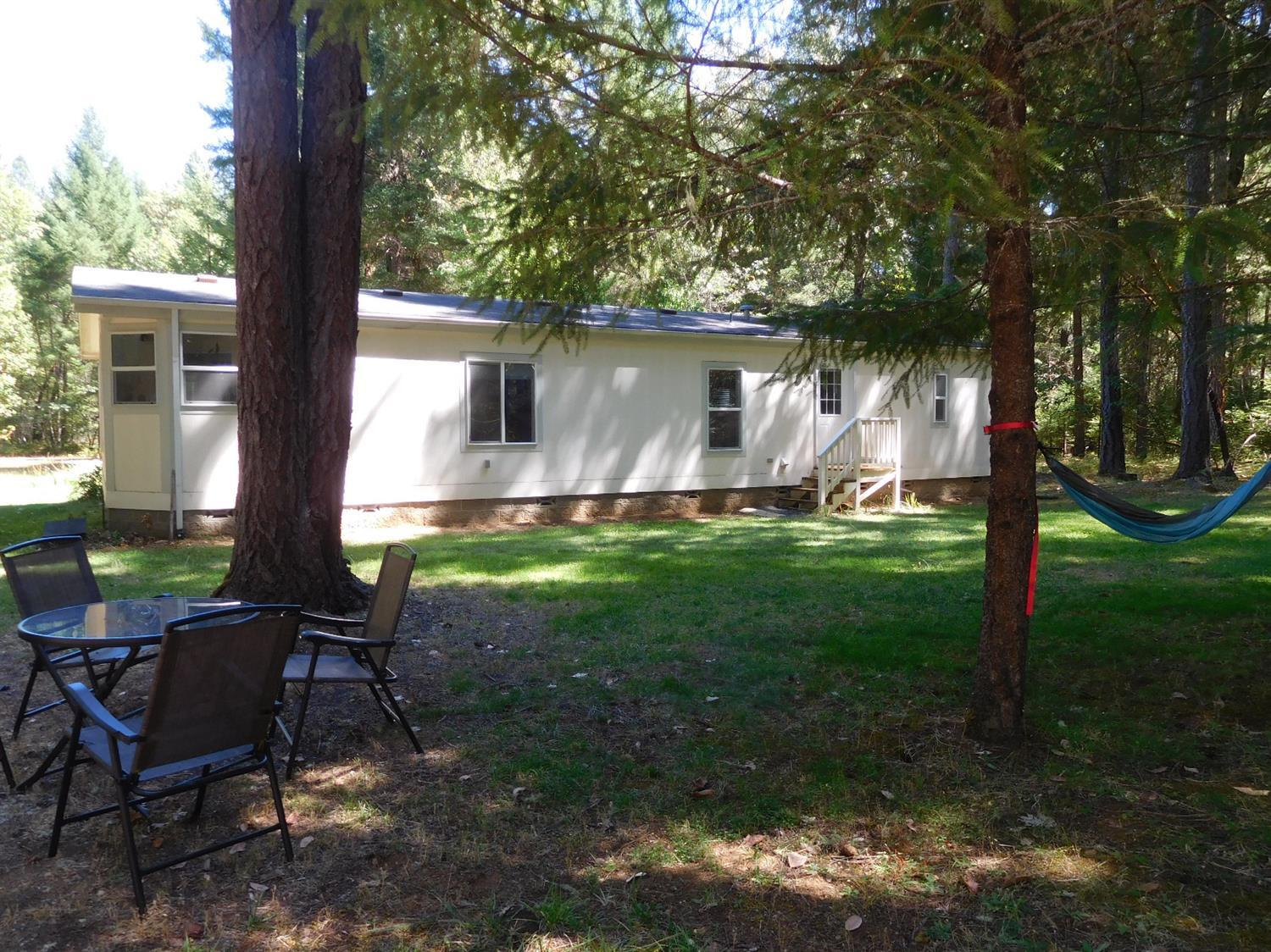 271 Kirkham Road Cave Junction, OR 97523 - Photo 25 of 33 Back of home, lawn has inground sprinkle