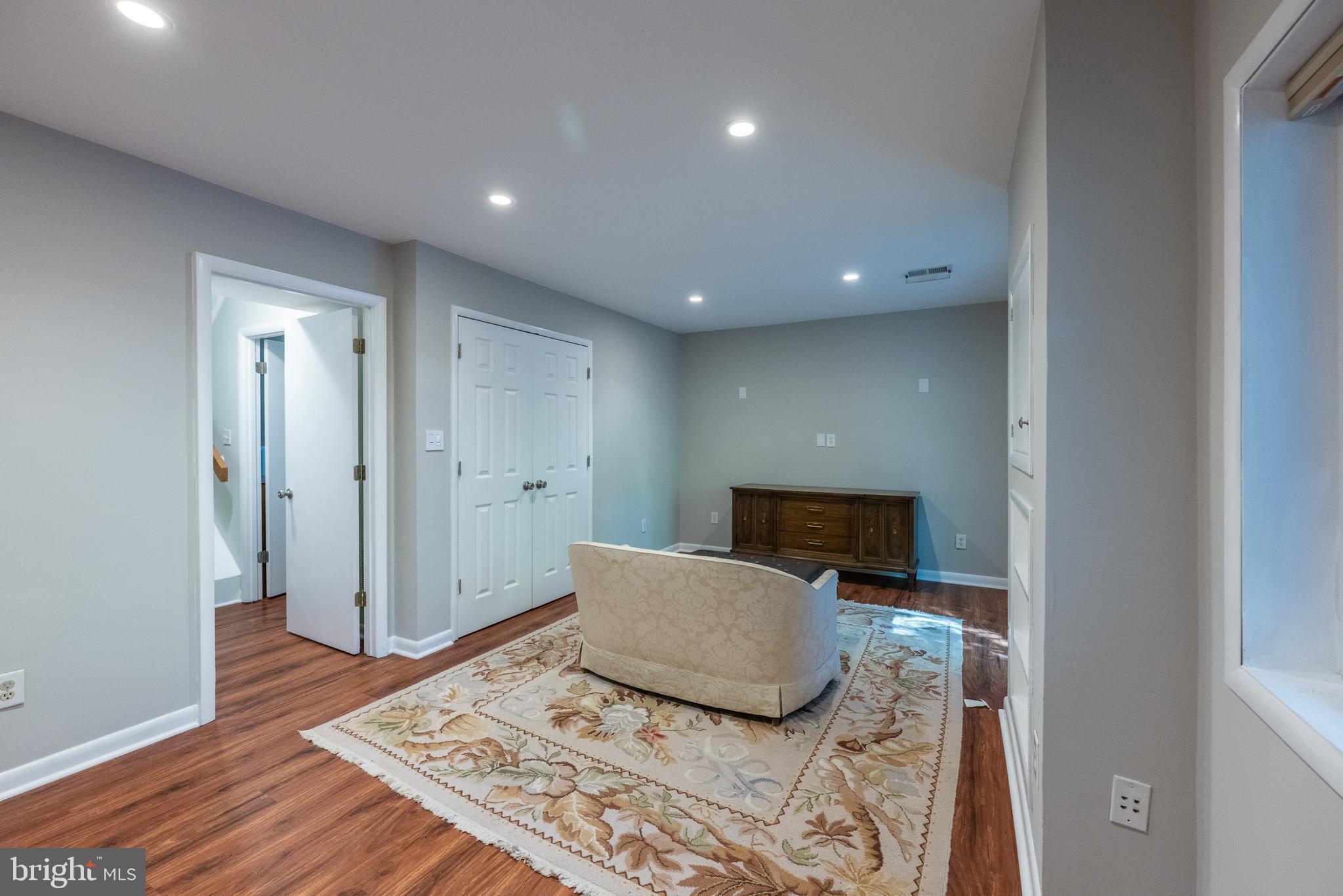 11917 Barrel Cooper Court Reston, VA 20191 - Photo 37 of 59 a bedroom with a bed and a lamp with wooden floor